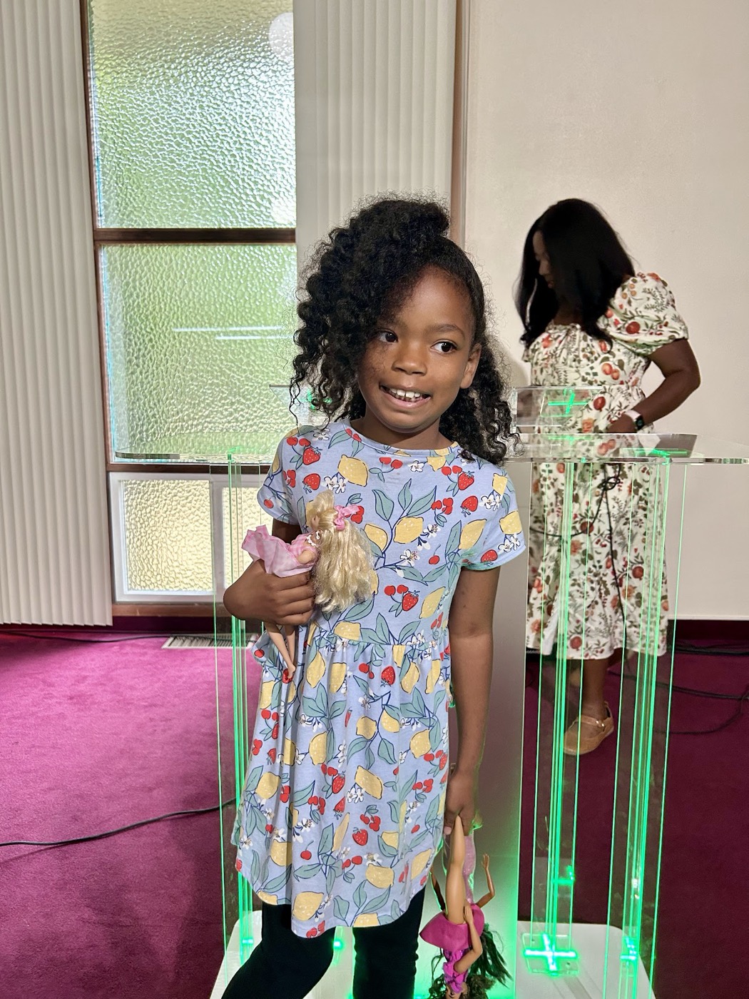 A young girl smiling in the sanctuary at Purpose Kids, The Purpose Church