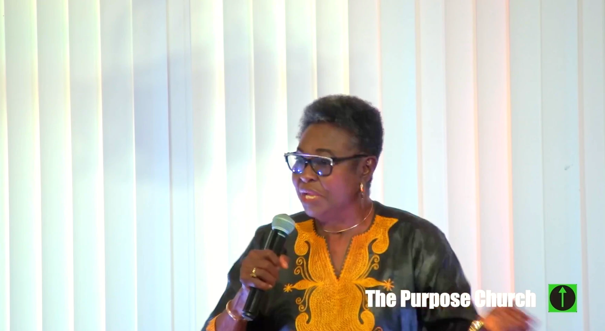 A woman bringing a word during Sunday worship at The Purpose Church in Kent, WA